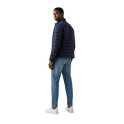 Navy blue quilted polyester Calvin Klein Jeans men zip puffer jacket in size L shown from the back side