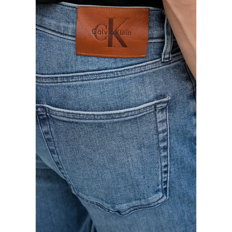 Back side view of men blue cotton denim jeans with a zip pocket and brown leather Calvin Klein brand patch