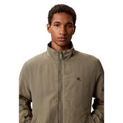 Calvin klein jeans men green nylon blazer featuring a subtle textured olive green zip-up jacket with embroidered logo