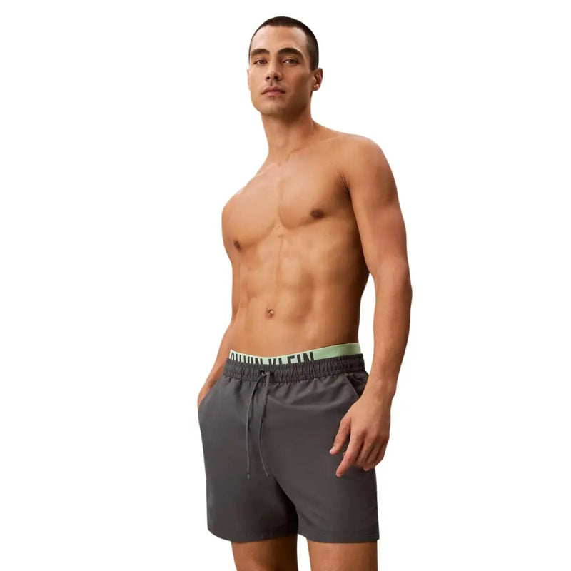 Calvin Klein Jeans men grey polyester swim shorts medium with dark gray trunks and light green waistband logo