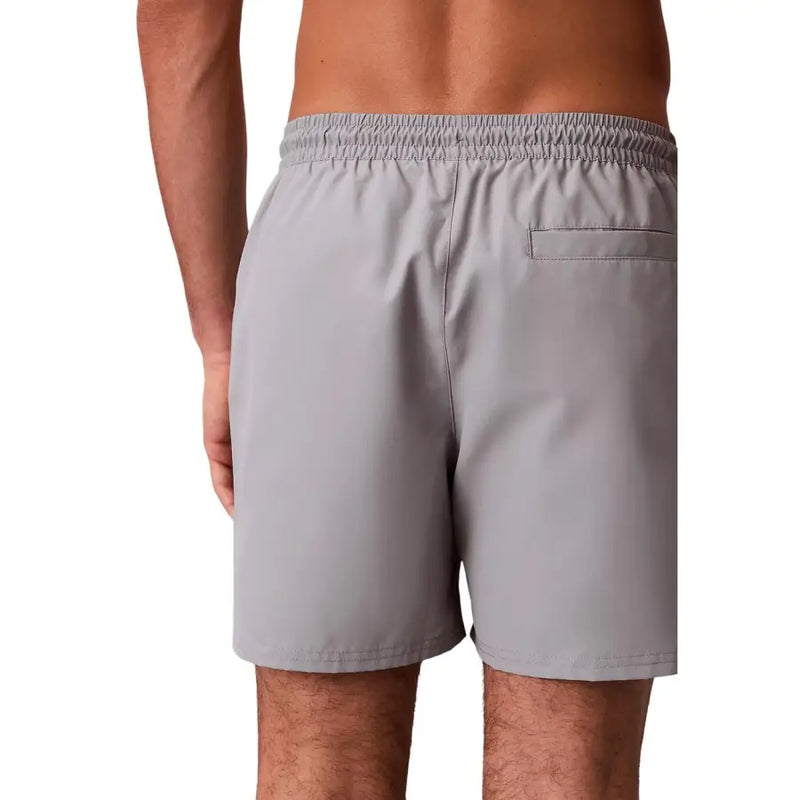 Calvin klein jeans men grey polyester swim shorts medium showing the back side with elastic waistband and single pocket