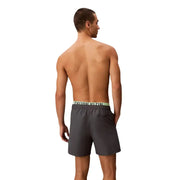 Calvin Klein Jeans men grey polyester swim shorts with dark grey fabric and light green waistband featuring logo