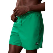 Calvin Klein Jeans men medium grey polyester swim shorts with vibrant green Calvin Klein swim trunks and drawstring waistband