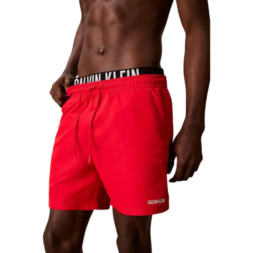 Calvin Klein bright red polyester swim trunks with black waistband and white branding for men medium size