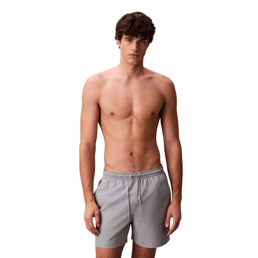 Calvin Klein Jeans men grey polyester swim shorts medium with a drawstring waistband for comfortable fit