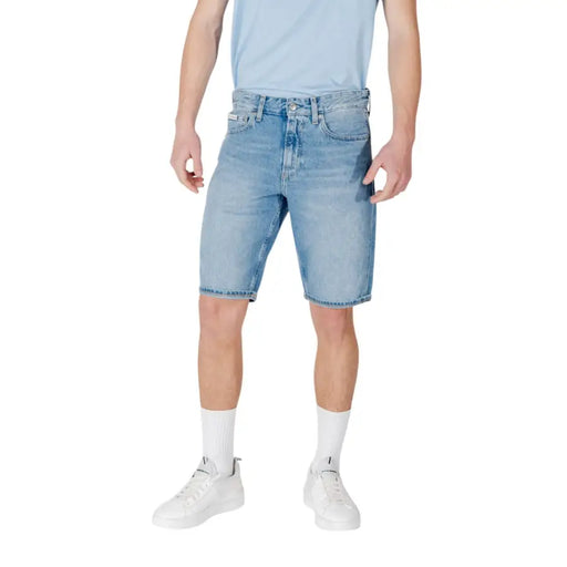 Calvin Klein Jeans men light blue cotton shorts featuring light-wash denim with five pockets and distressed detailing
