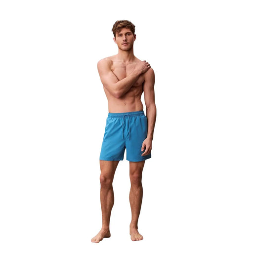 Calvin Klein Jeans men light blue polyester swim shorts featuring bright blue swim trunks with a drawstring waistband