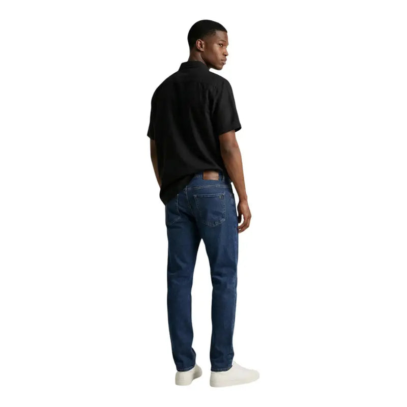 Dark blue denim jeans with a classic five-pocket design and faded wash in Calvin Klein Jeans men shirt product