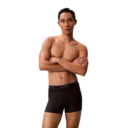 Black Calvin Klein Jeans men swimwear boxer briefs with subtle elastic waistband featuring white logo lettering