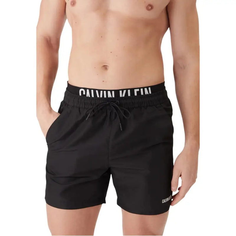 Black Calvin Klein Jeans men swimwear swim trunks with white logo branding on waistband and side for swimming use