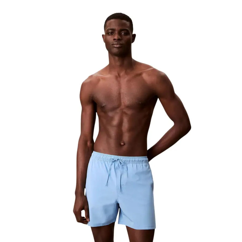 Light blue Calvin Klein Jeans men swimwear swim trunks with a drawstring waistband for comfortable fit