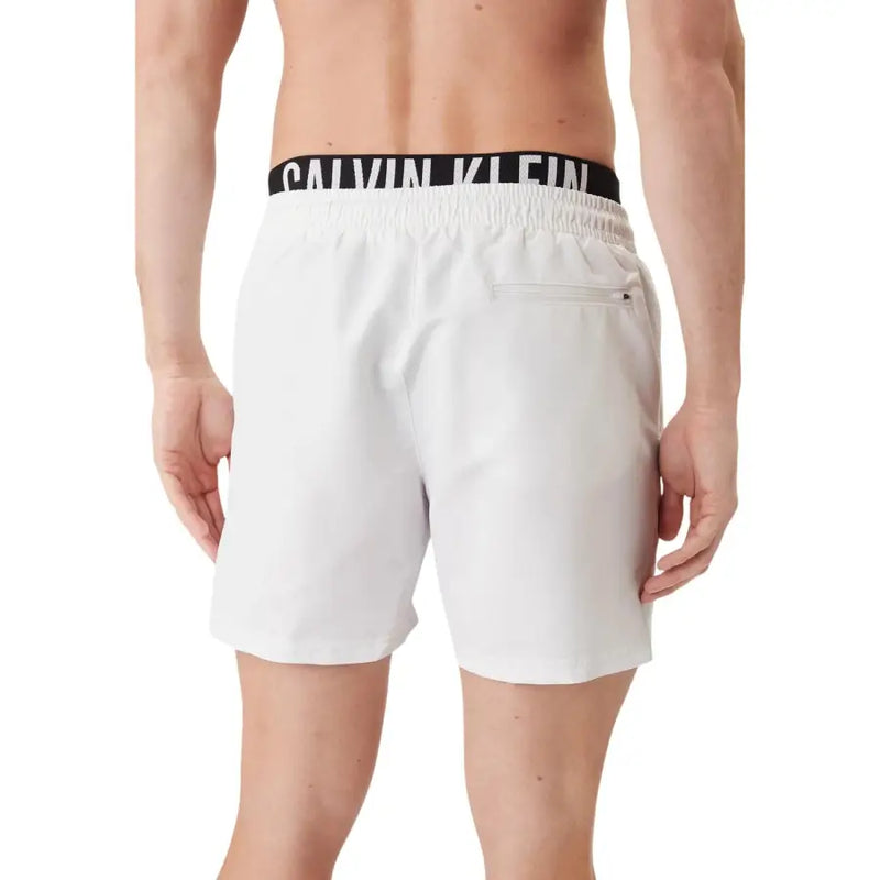 White calvin klein jeans men swimwear trunks with black elastic waistband and white logo lettering
