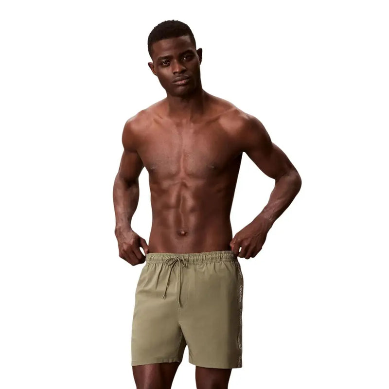 Calvin Klein Jeans men olive green swimwear shorts with drawstring waistband and subtle side panel detailing