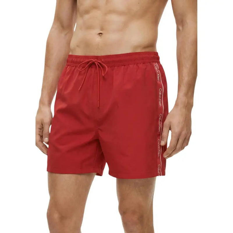 Calvin Klein Jeans men swimwear red swim trunks with white logo stripe along the side for beachwear use