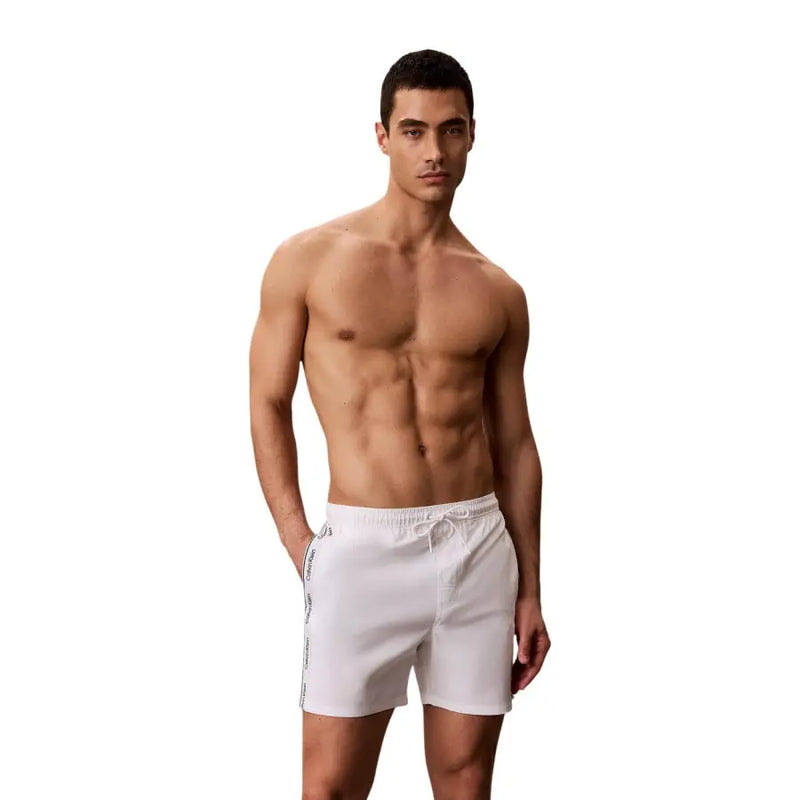 White Calvin Klein Jeans men swimwear trunks with subtle side stripe detail ideal for swimming and beachwear