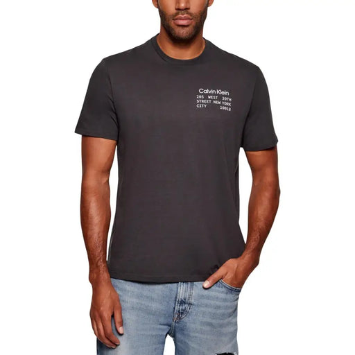 Dark gray calvin klein jeans men t-shirt with white text 205 west 39th street new york city 10018 on chest