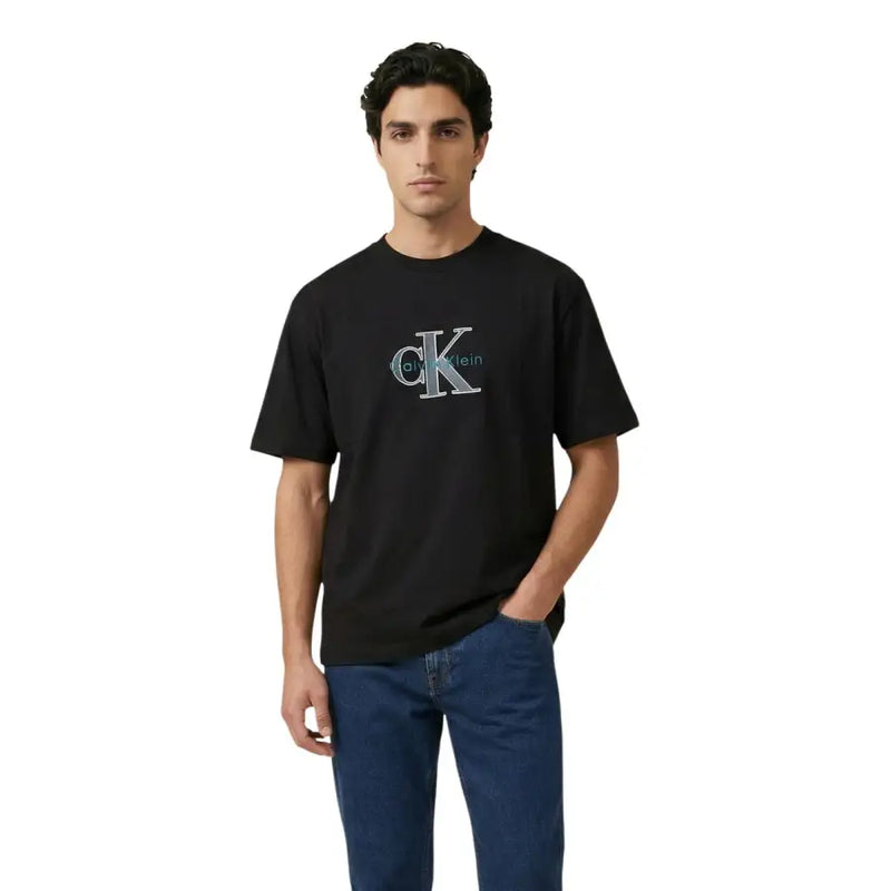 Black Calvin Klein Jeans men t-shirt with prominent embroidered ck logo in teal and silver detailing