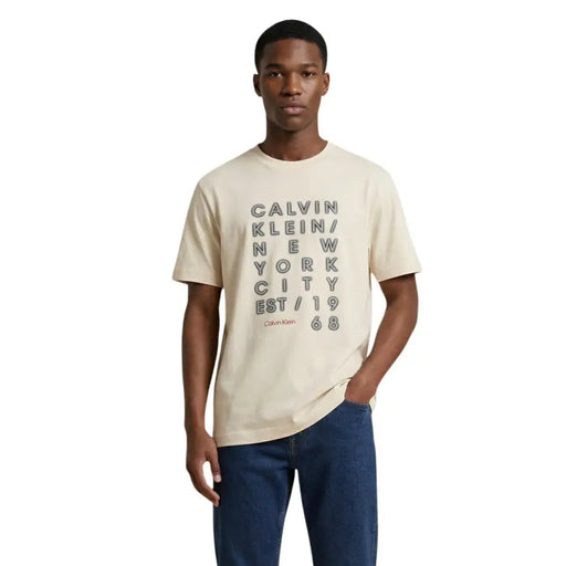 Cream-colored calvin klein jeans men t shirt with bold black stacked text print and smaller red brand name in cotton