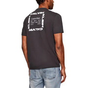 Dark gray calvin klein jeans men t-shirt showing the back with bold white graphic print featuring vertical and horizontal text