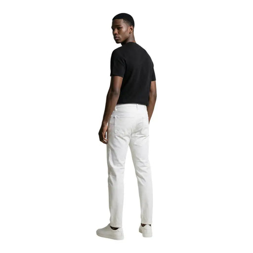 White slim-fit denim jeans by calvin klein jeans for men showcasing a modern casual style