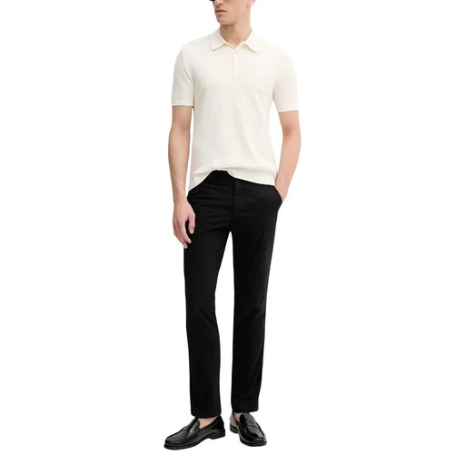 Calvin Klein Jeans men trousers paired with a cream-colored ribbed knit polo shirt with classic collar and short sleeves