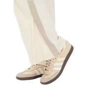 Beige adidas samba sneakers with white stripes and brown rubber soles paired with Calvin Klein Jeans women beige cotton trousers