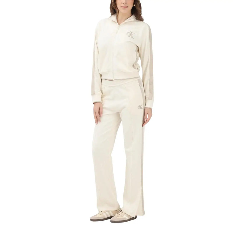 Beige cotton calvin klein jeans women trousers with subtle embroidered logos on thigh and matching zip-up track top