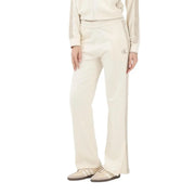 Calvin Klein Jeans women beige cotton trousers featuring cream-colored track pants with side slit and embroidered logo