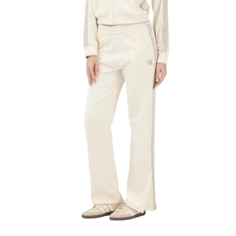 Calvin Klein Jeans women beige cotton trousers featuring cream-colored track pants with side slit and embroidered logo