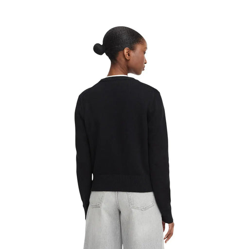 Calvin Klein Jeans women black cotton knitwear jumper with ribbed cuffs and hem worn over light-wash denim pants