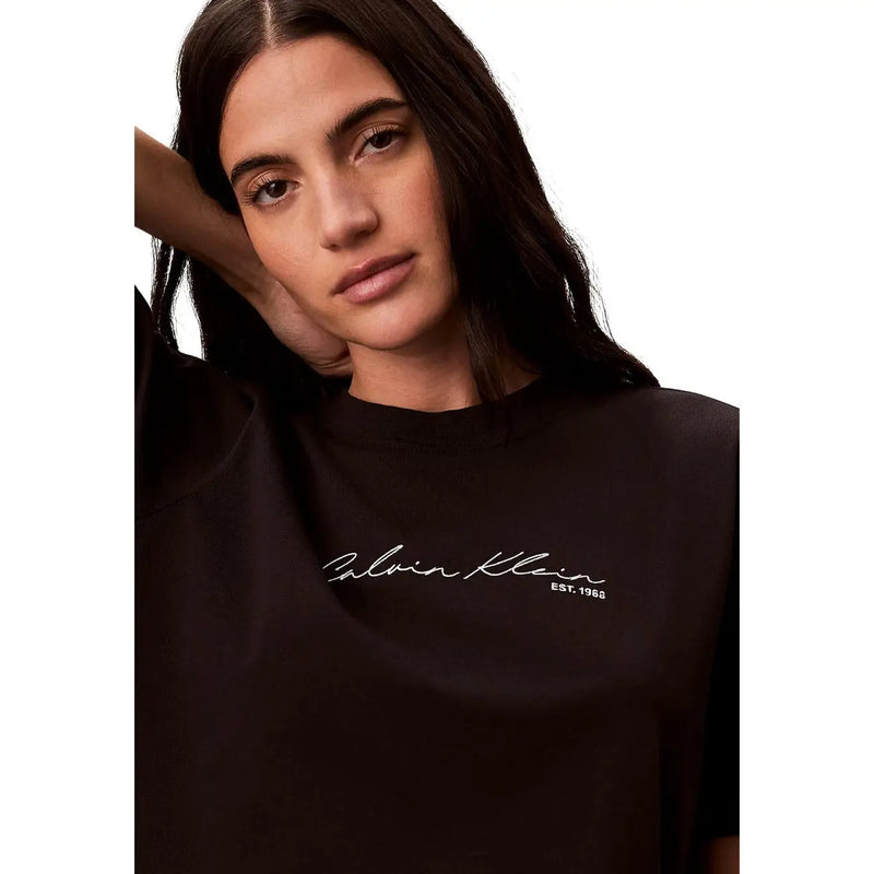 Black cotton round neck Calvin Klein Jeans women t shirt with white cursive logo and est detail on front