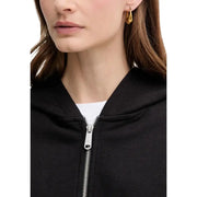 Gold hoop earrings with a sleek modern design paired with a calvin klein jeans women black hooded zip sweatshirt