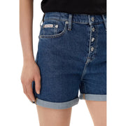 Dark blue cotton denim shorts with button-front closure rolled cuffs and Calvin Klein label on back pocket