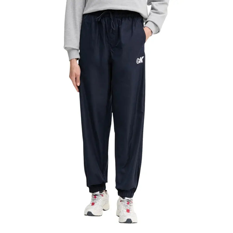 Navy blue polyester drawstring jogger pants with white logo on left thigh from Calvin Klein Jeans women collection