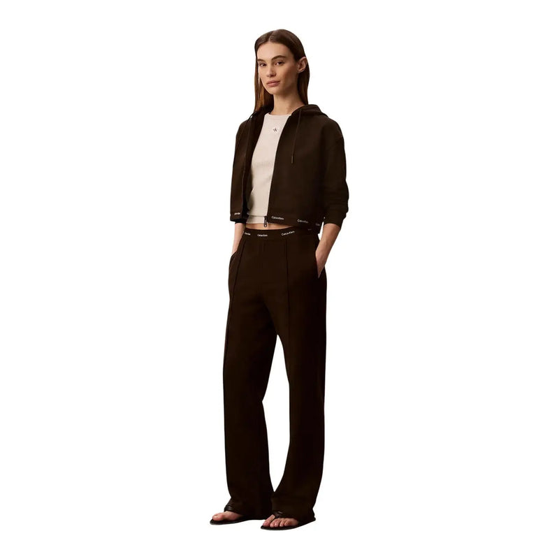 Black Calvin Klein cropped hoodie with ribbed cuffs and waistband paired with brown cotton Calvin Klein Jeans trousers