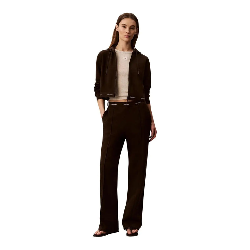 Black calvin klein hoodie with ribbed cuffs and waistband and subtle logo detail paired with brown cotton trousers