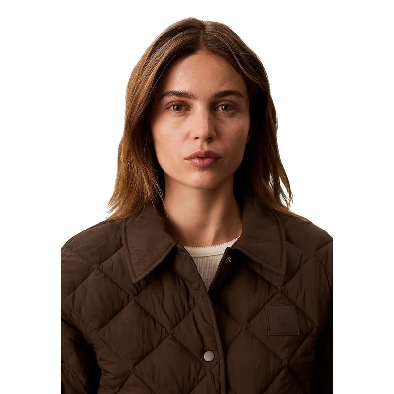 Brown quilted nylon jacket for women by Calvin Klein Jeans with classic collar and button closure