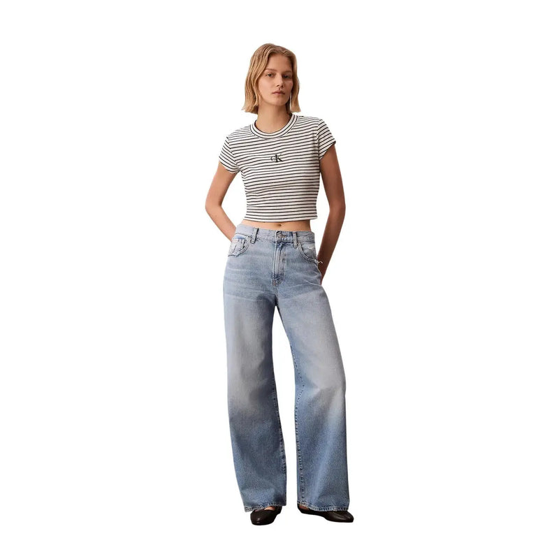 A pair of light-wash wide-leg denim jeans with classic five-pocket design paired with calvin klein jeans women striped round neck black top