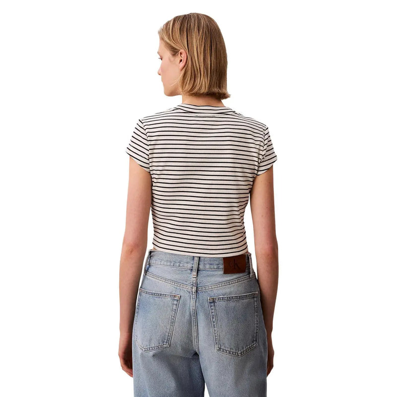 A woman wearing a Calvin Klein Jeans women black short-sleeved fitted striped round neck top