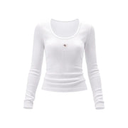 White ribbed long-sleeve cotton lycra top for women with subtle calvin klein logo patch at the chest