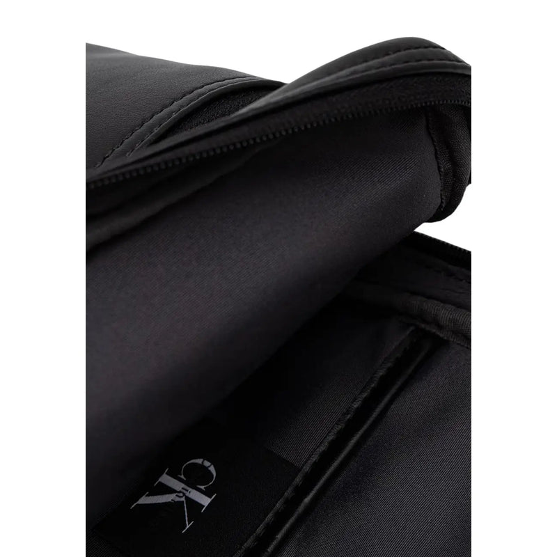 Calvin klein men bold logo webbing sling bag black with sleek minimalist design and subtle stitching details
