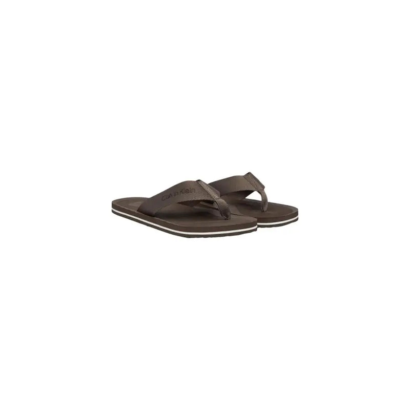 Calvin Klein men brown polyester flip-flops with textured strap and white trim along the sole