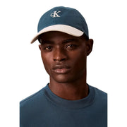 Blue and cream two-tone baseball cap with white ck logo embroidery made of 100 percent cotton by Calvin Klein