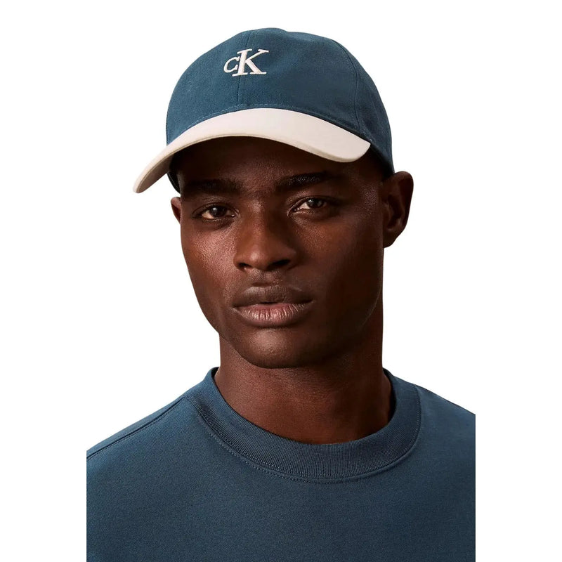Blue and cream two-tone baseball cap with white ck logo embroidery made of 100 percent cotton by Calvin Klein