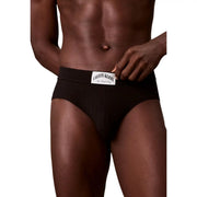 Black calvin klein men cotton hip briefs with a white label featuring the brand name and new york city text