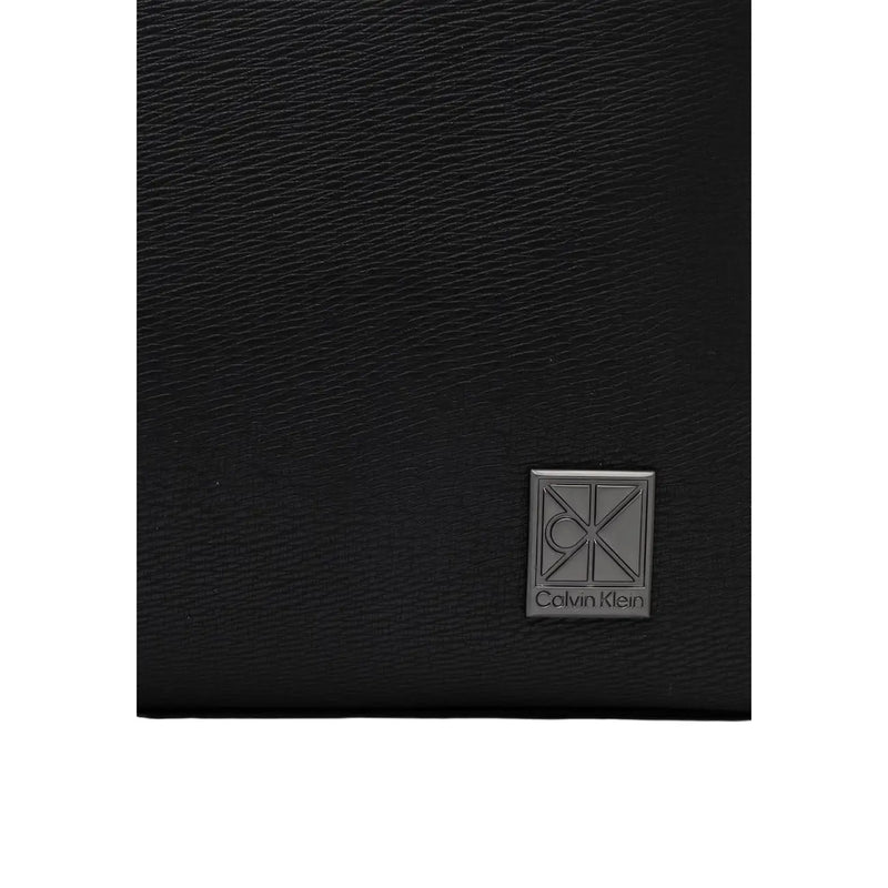 Black textured leather wallet with silver Calvin Klein logo plaque shown with Calvin Klein men emblem flap backpack black polyurethane size W29