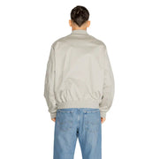 Light grey bomber jacket with ribbed hem and cuffs paired with light blue relaxed-fit jeans