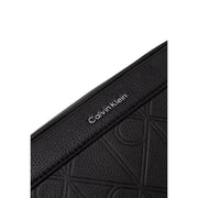 Black textured leather Calvin Klein men crossbody bag with embossed logo pattern measuring W16 x H22 cm