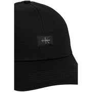 Calvin Klein men monologo black cotton trucker cap with subtle textured fabric and small black embroidered logo patch