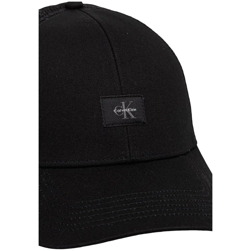 Calvin Klein men monologo black cotton trucker cap with subtle textured fabric and small black embroidered logo patch